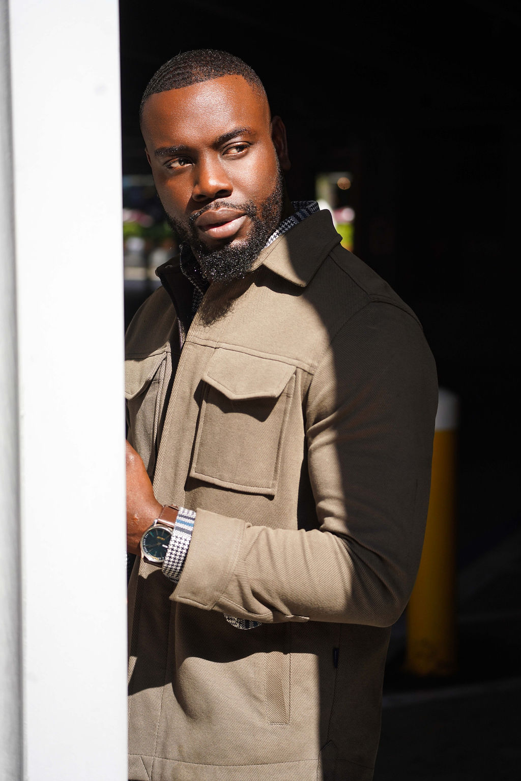 Man wearing a khaki coat with a blurred background